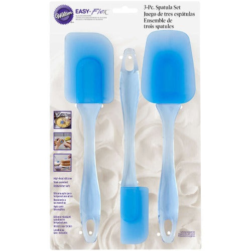 Spatula Set - 3 Piece by Wilton. The set includes three spatulas in different sizes, each with a flexible silicone head and ergonomic handle. The spatulas are designed for mixing, scraping, and spreading, and feature vibrant colors and durable, heat-resistant construction